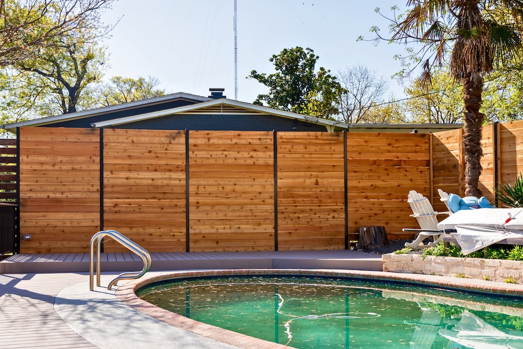 Tall wooden privacy fence offering full coverage for a residential property