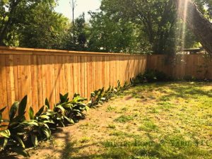 backyard view with wood fence featuring decorative top cap rail