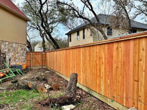 Freshly installed wooden privacy fence in a residential backyard