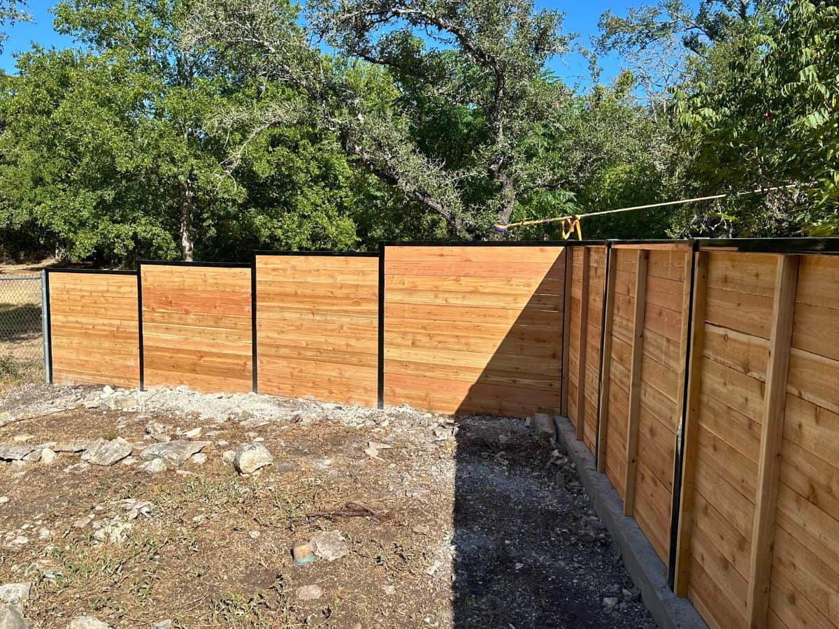 Modern cedar wood fence with black metal frame