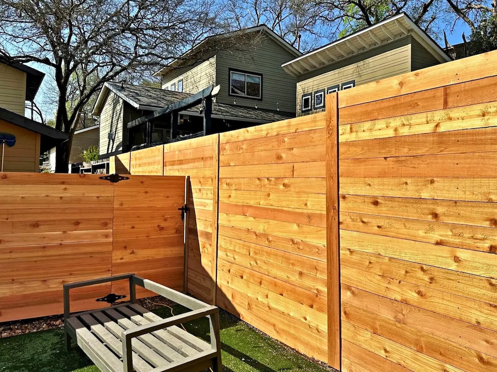 Traditional wood fence enclosing a suburban residential property