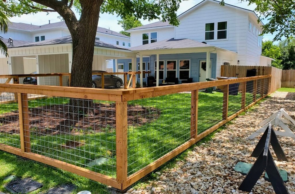 residential property bordered by steel bull panel ranch-style fence