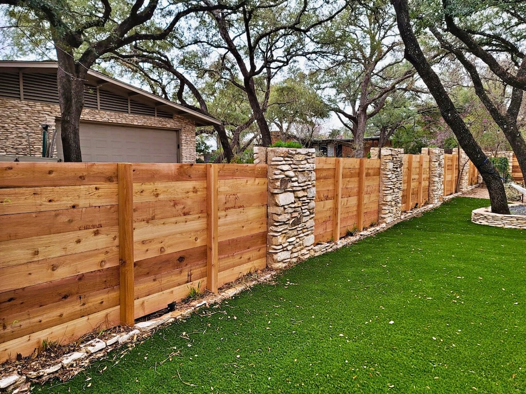wooden privacy fence with masonry stone post accents