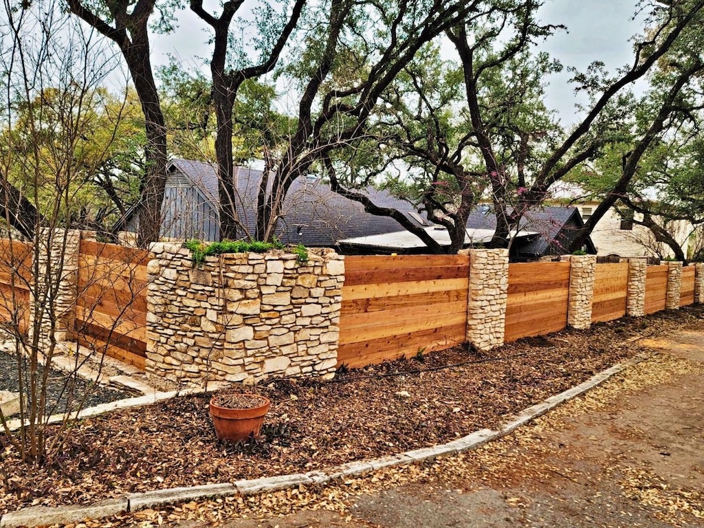 Traditional wood fence enclosing a suburban residential property